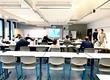 Klassenzimmer mit Studierenden die an ihrem Platz sitzen und ein Dozierender der vorne steht und etwas erzählt